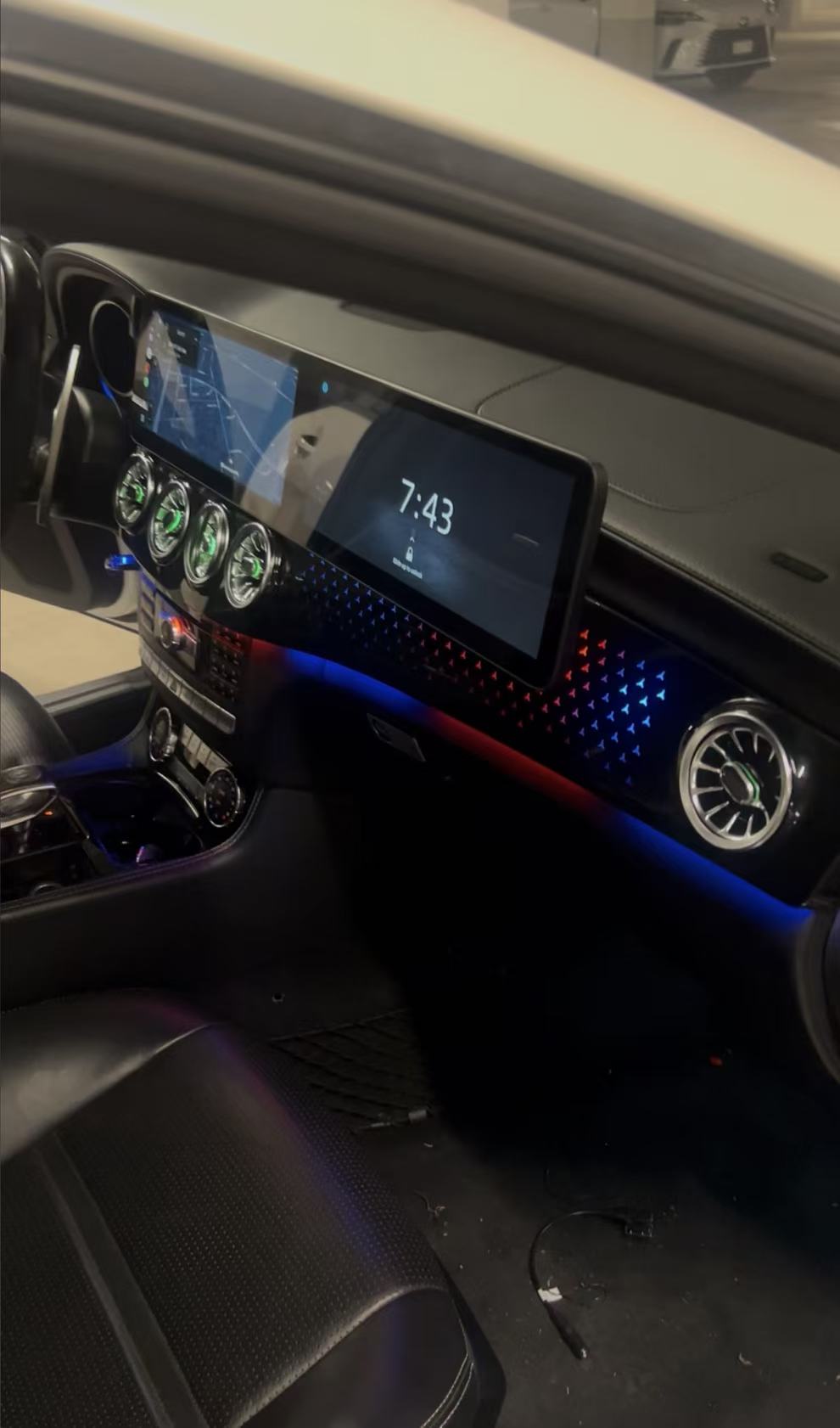 Mercedes interior with digital display and red and blue ambient lighting